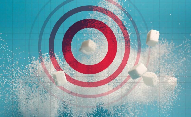 Cubos de açúcar e alvo vermelho em fundo azul com grade.