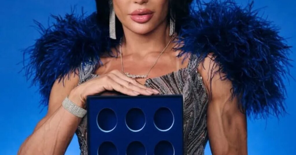 Mulher vestida elegantemente segura um objeto azul com seis círculos vazados.