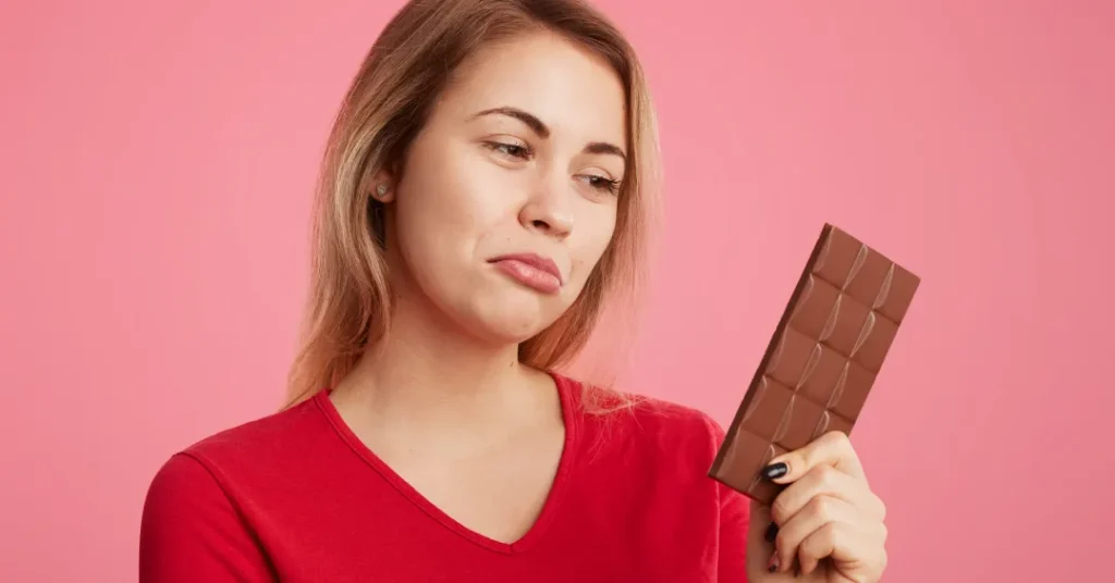 woman looks with discontent expression sweet bar chocolate keeps diet can t eat it be slim sporty.jp